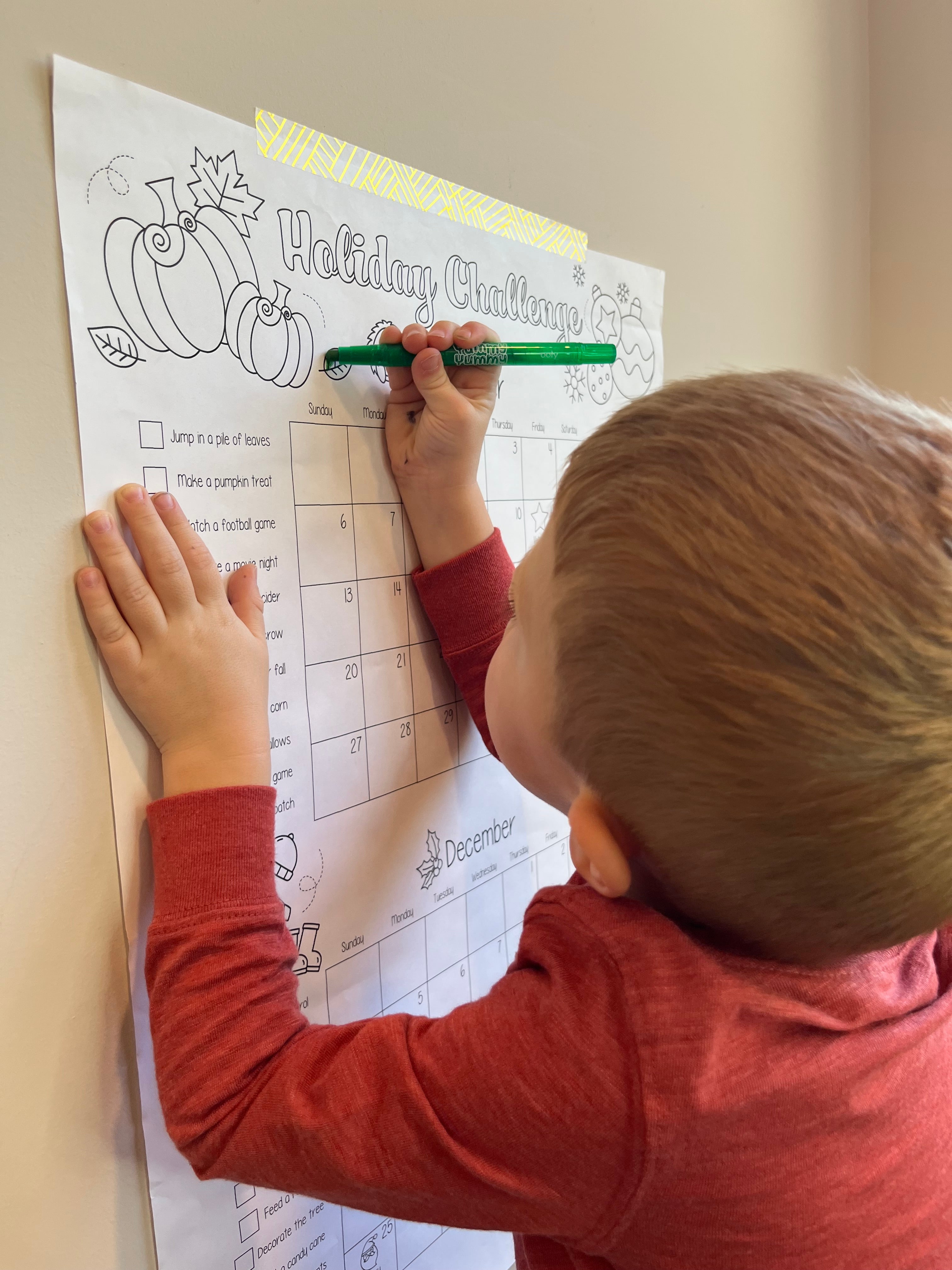 Small child coloring a jumbo holiday countdown calendar