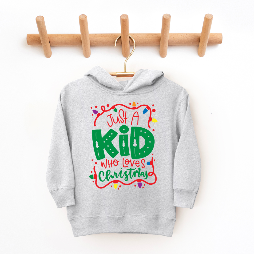 Kringle Krate Christmas Store "Just a Kid Who Loves Christmas" Youth Hooded Sweatshirt